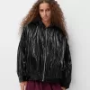 Shiny effect bomber jacket with over print